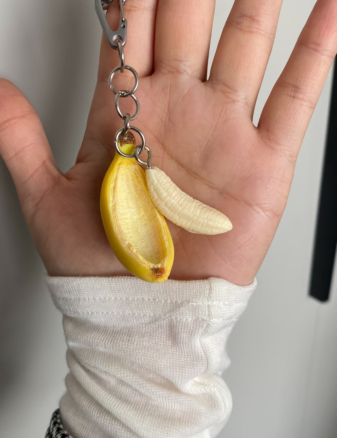 Peelable banana charm held in hand - novelty fruit ornament and unique gift from Asia, Salt.a.Peper gift shop